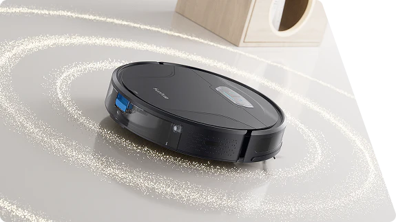 Robot aspirador Honiture G20 Pro negro limpiando residuos en círculo sobre el suelo con sus cepillos en movimiento.